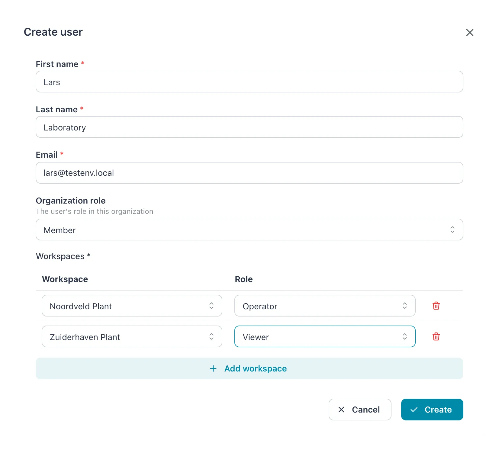 Create user dialog with name, email, organization role Member and two workspace rows